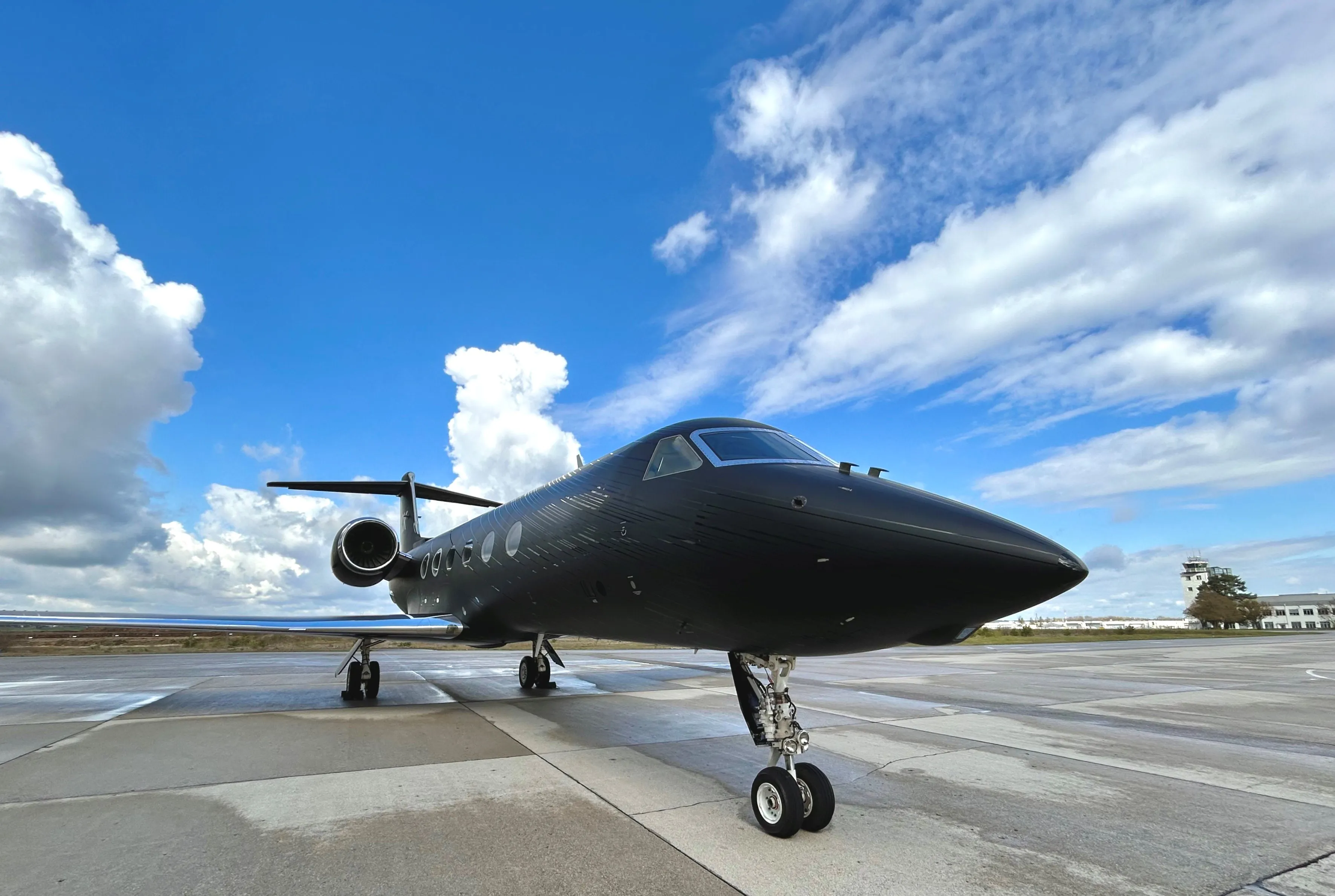 Dark business jet photographed outside after paint work