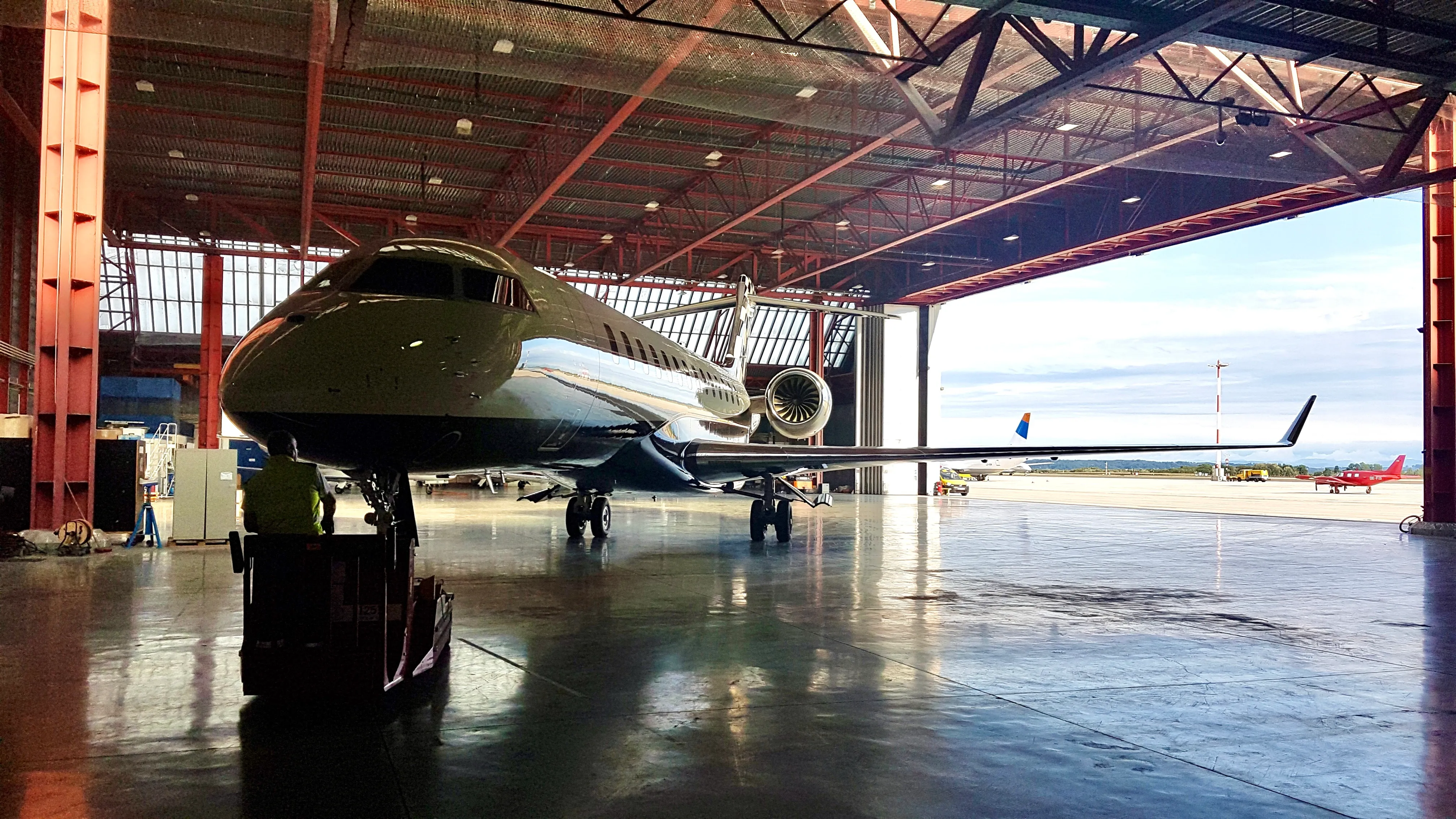 Business aircraft positioned at the hangar door