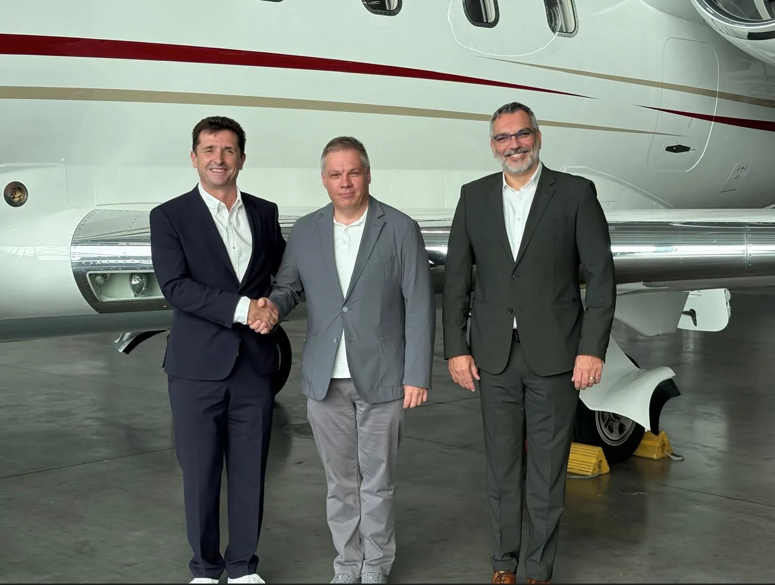 AMX Support and GE Aerospace representatives marking the Authorized Service Center designation